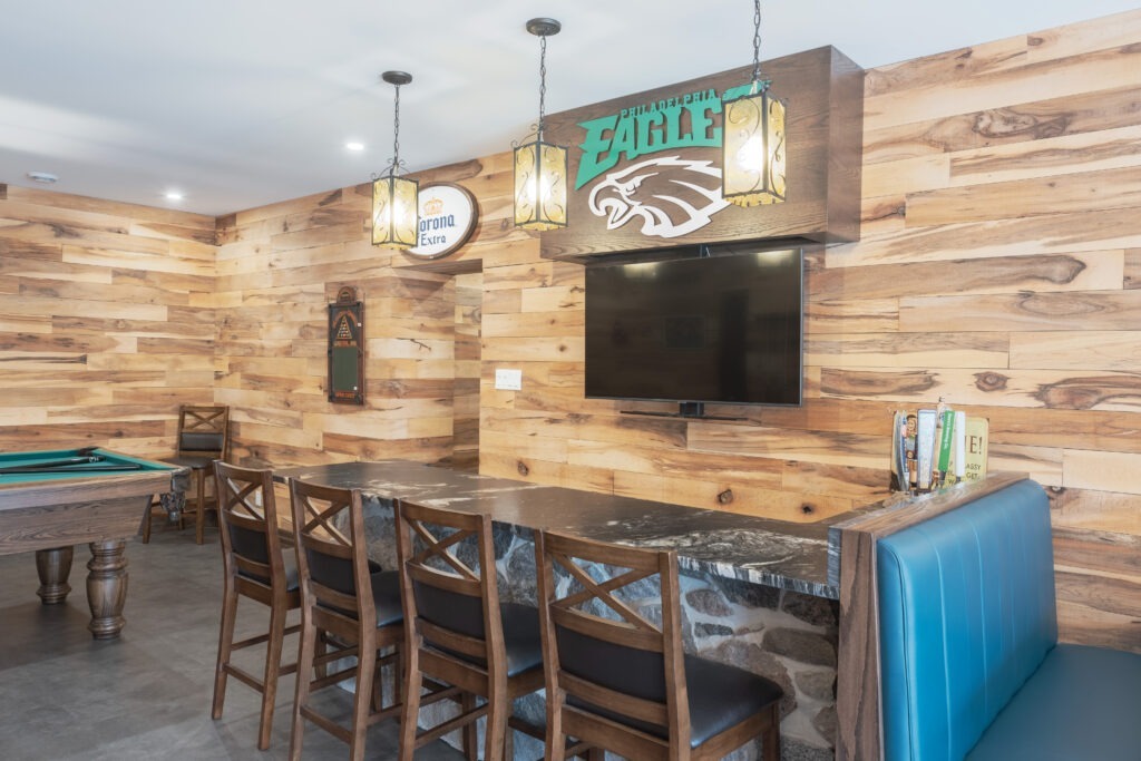 Rustic basement grandroom with kitchenette, dining booth, natural stone bar and pool table